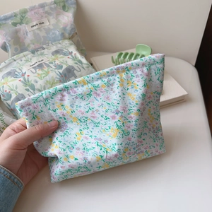 Assorted cotton cosmetic bags with floral and elephant patterns in soft pastel colors