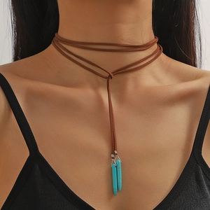 Brown multi-layer leather necklace with turquoise pointed pendants on a model