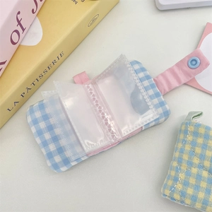 Internal view of blue plaid fabric mini photo album showing transparent PVC pocket slots