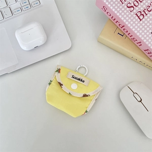 Close-up of a yellow contrast color fabric earphone pouch on a clean desk setup
