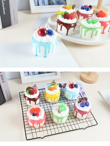 Macro detail of artificial mini cakes with realistic frosting and fruit toppings for decor