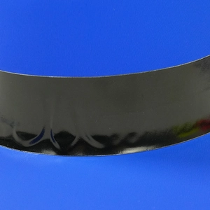 Macro shot of the smooth black brim detail and wavy edge design of a plastic party hat