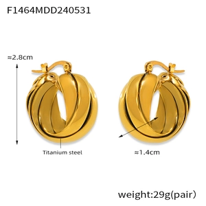 Close-up of golden titanium steel U-shape earrings featuring a twisted multi-layer design