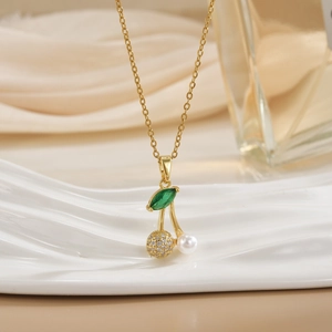 Close-up of cherry pendant with micro-pave crystals and pearl on gold chain