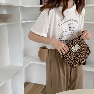Close-up of stylish leopard print canvas pouch with Pleasant Time label on display