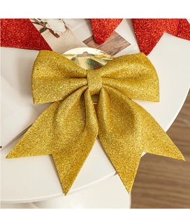 Close-up of large golden glitter Christmas bow with metallic shine for tree decoration