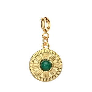 Detailed view of a gold sunburst pendant featuring a center-set green gemstone and bail