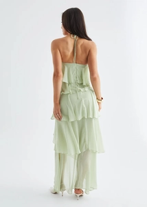 Detail of light green tiered chiffon maxi dress showing open back and layered ruffles