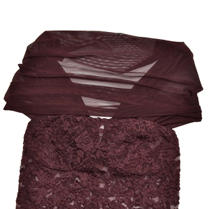 Detailed view of burgundy lace tube top and matching sheer mesh shawl set on white background