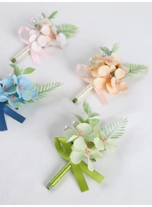 Detailed view of floral boutonniere set with silk hydrangeas and elegant ribbon bows