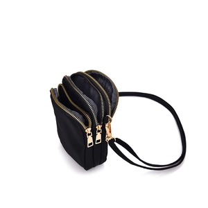 Lightweight black nylon phone bag with multiple gold zip compartments and shoulder strap
