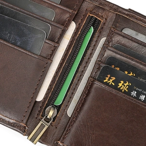 Macro detail of brown genuine leather wallet interior with card slots and metal zipper