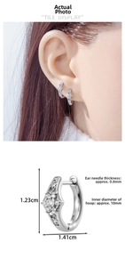 Detail view of starburst stud earrings with dimensions 1.41cm width and 10mm inner diameter