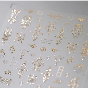 Detailed view of gold embossed nail art stickers with vintage heart and floral patterns