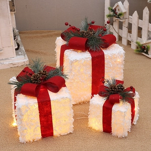 Three-piece set of white flocked LED Christmas gift boxes with red bows and pine cones