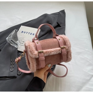 Close-up of pink barrel bag featuring soft faux fur trim and stitched PU leather details