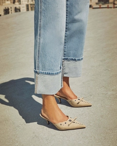 Beige pointed-toe kitten heel mules with eyelet details and bow on suede texture