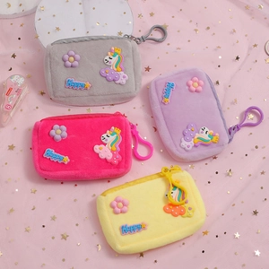 Macro shot of colorful plush unicorn coin purses with happy embroidery and plastic hooks