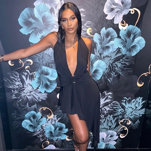 Elegant black halter neck dress with plunging V-neck and stylish ring detail for women
