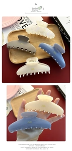 Detail shot of Morandi colored acetate hair claws in blue, cream and grey shades