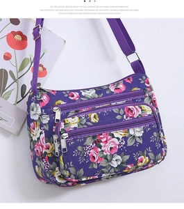 Close-up of lightweight purple floral shoulder bag with multiple functional zipper pockets
