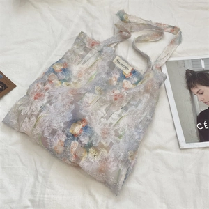 Detailed close-up of floral lace tote bag with artistic pattern and soft texture