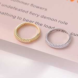 Macro shot of gold and silver full-diamond alloy rings with detailed side profile