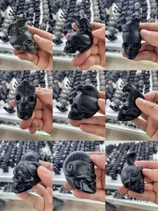 Detailed collection of assorted black obsidian skull carvings with animal motifs