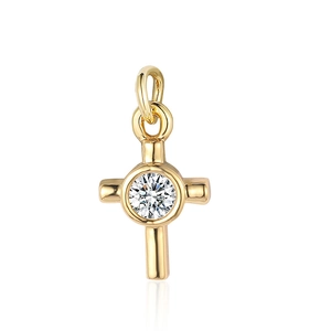 Detailed view of golden cross pendant with a clear zircon stone center on white background