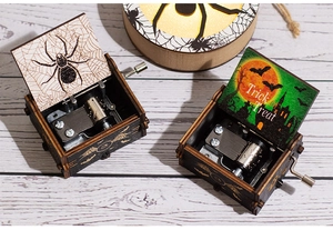 Detail of wooden Halloween music boxes featuring spider web and Trick or Treat designs