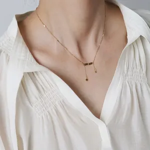 Gold-plated titanium necklace with olive green crystal beads and delicate fringe tassels