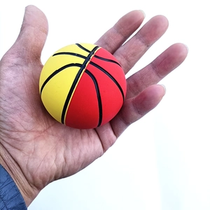 Red and yellow 6cm elastic mini rubber basketball toy ball held in hand on white background