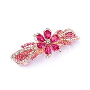 Detail of rose gold hair clip with pink crystal flower and sparkling rhinestones