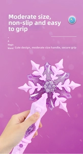 Close-up of snowflake magic wand toy with purple star center and pink heart buttons