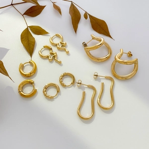 Abstract geometric gold hoop earrings with twisted lines and colorful enamel drip
