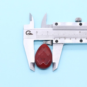 Caliper measurement of a faceted watermelon crystal teardrop pendant with metal clasp