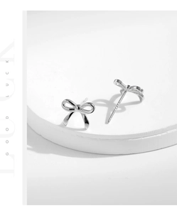 Macro shot of S925 sterling silver bow stud earrings with clear material engraving