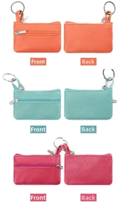 Macro detail of three zipper coin purses in orange, blue and pink with lychee texture