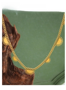 Detailed view of 18K gold-plated titanium necklace with five sunburst pendants