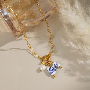 Blue and white porcelain pendant necklace with gold paperclip chain and white pearl
