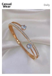 Close-up of rose gold double-layer open bangle with shimmering cubic zirconia stones