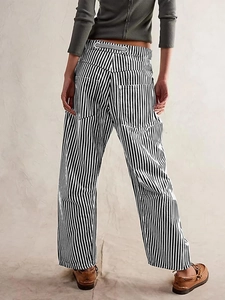 Wide-leg vertical striped pants in black and white with drawstring waist and side pockets