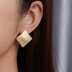 18K gold plated stainless steel square heart earrings with white enamel stripes on model