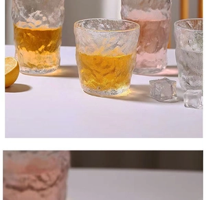 Close-up of glacier-textured heat-resistant glass cups with lemon slices and ice cubes
