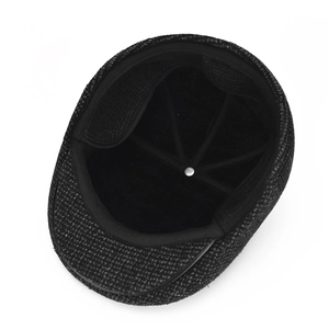 Close-up of winter warm peaked cap showing thick inner fleece and durable textile texture