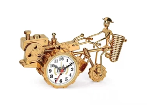 Detail of vintage tractor quartz clock with golden metallic finish on white background