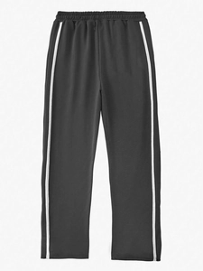 Detail of men's casual joggers showing elastic drawstring waist and side stripes