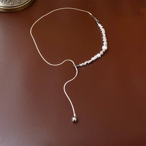 Close-up of adjustable silver snake chain with Baroque pearl and metallic beads