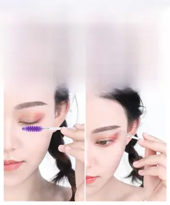 Detail of purple spiral spoolie brush with glitter handle for eyelash and eyebrow grooming