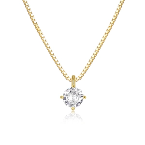 Macro shot of gold-plated silver necklace featuring a four-prong set solitaire zircon